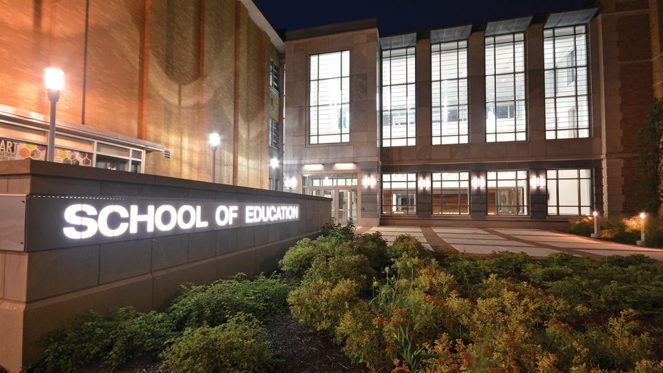 Outside of Wilber Hall, viewed lit up at night