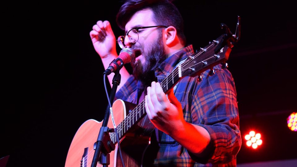 Zach Robinson plays the guitar and sings