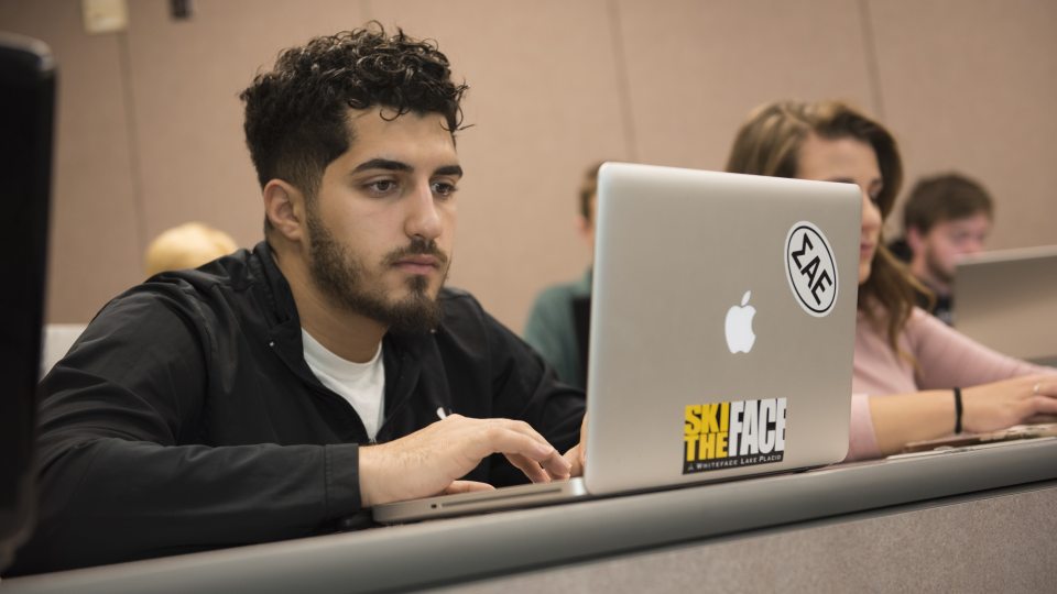 Student taking notes in class
