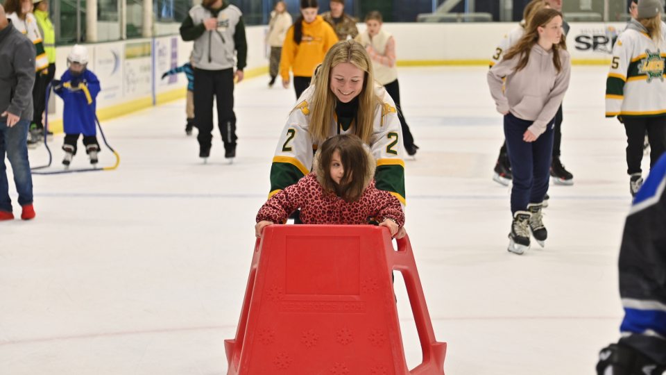 Mack Hall skates with a young Laker fan