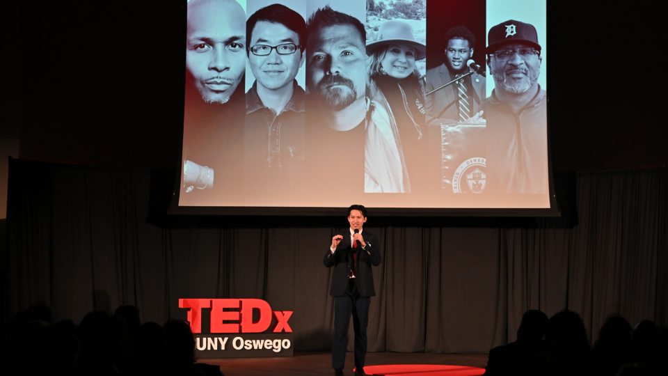 Eason Lee introduces the inaugural TEDxSUNY Oswego in April 2025