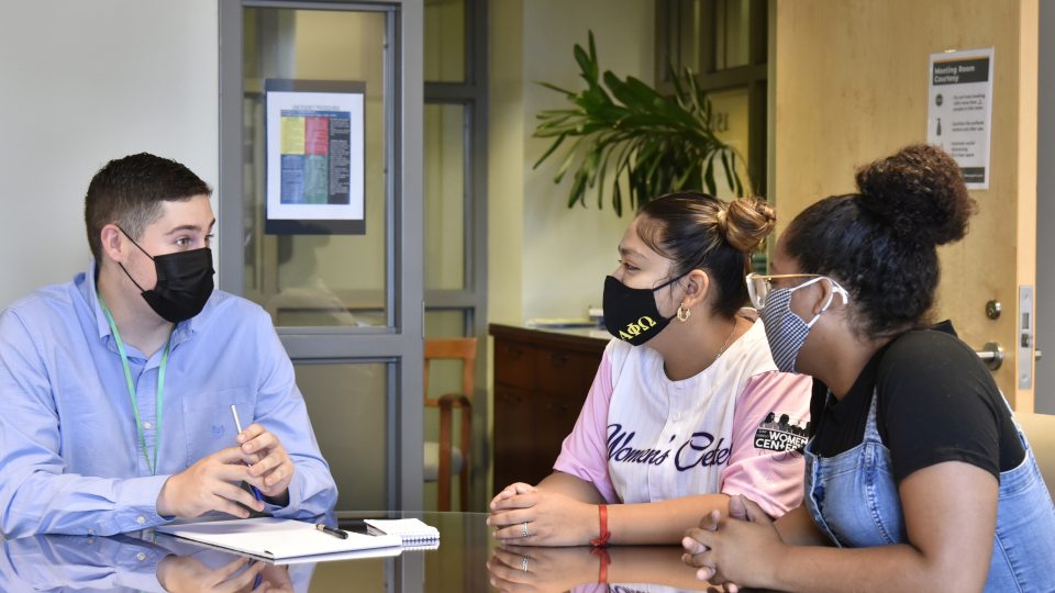 Advisement Center student guides having discussion in new office space