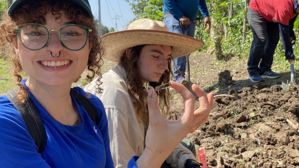 Anthropology major Jylene Figueroa holds up a discovery from a dig earlier this year in Veracruz, Mexico, as part of a National Science Foundation funded research project