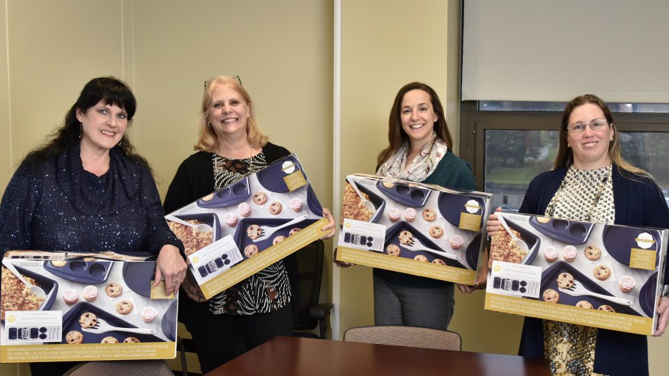 Four winners of the SEFA Bake Off receive baking sets as prizes