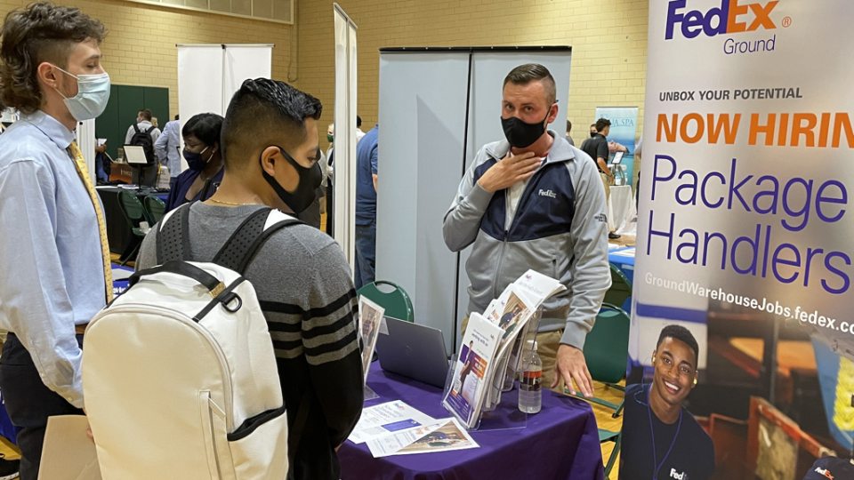Student meet with a FedEx representative at a previous career and internship fair