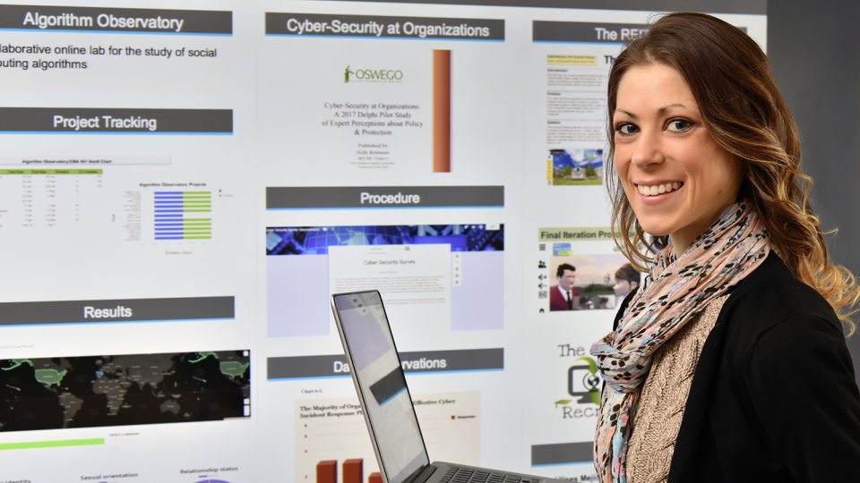 Holly Reitmeier with cybersecurity research poster