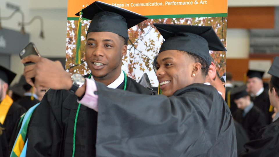 Two students take selfie before December Commencement