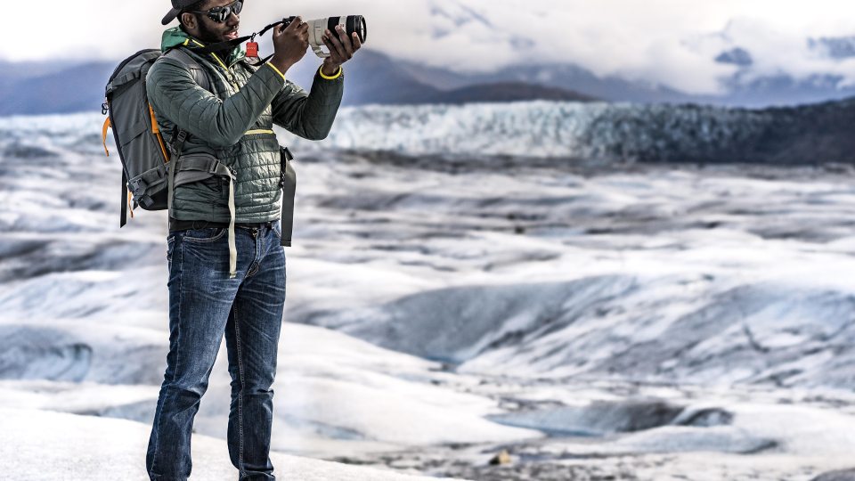Mic-Anthony Hay takes photographs on a glacier in Alaska