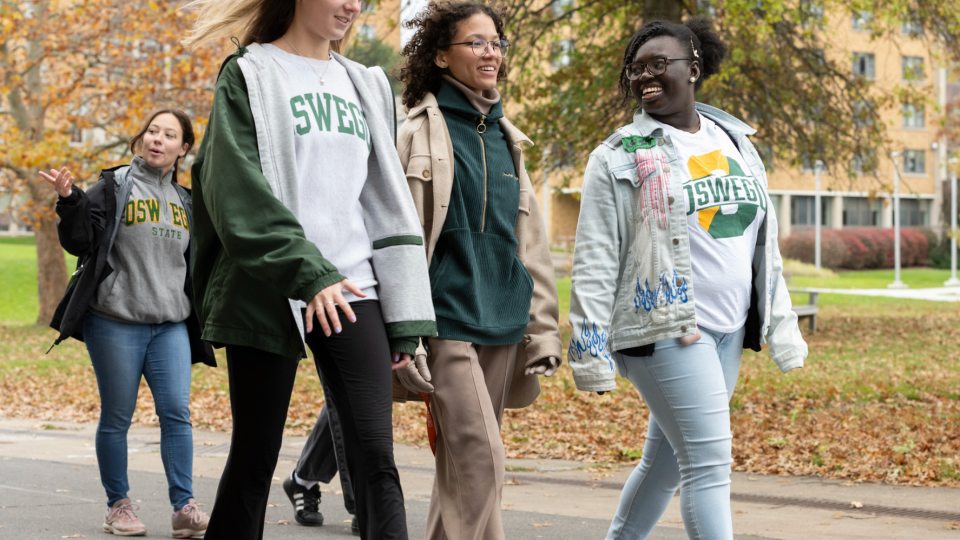 Students walk across campus on a fall day