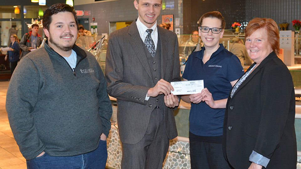 Organizers of Miss-A-Meal drive, Auxiliary Services staff pose with check