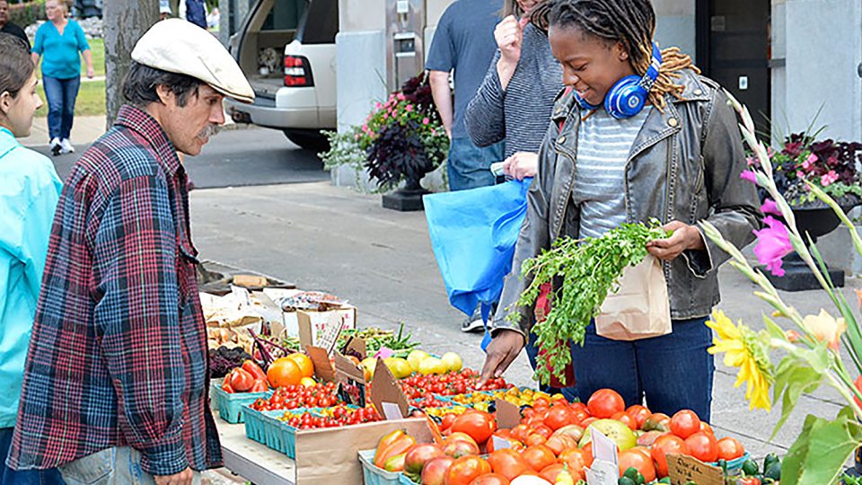 Student buys fresh goods at Farmers Market