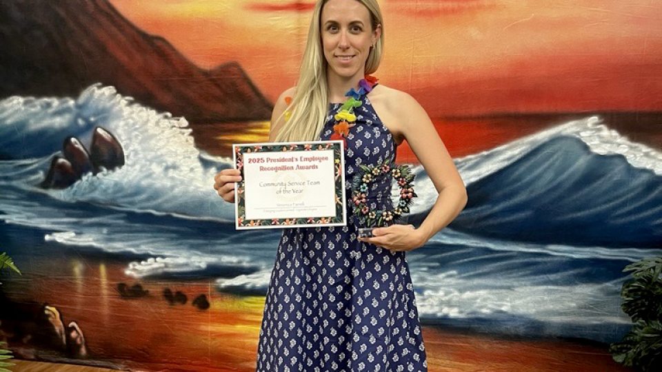 Veronica Farrell accepts an award while chairing SUNY Upstate's Emerging Leaders Unit. A rising star who sought a degree to complement and continue career development, Farrell is graduating from SUNY Oswego with an integrative professional studies degree
