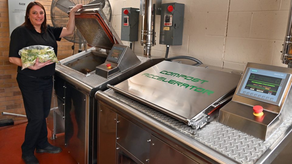 Kelly McKinney, Lakeside Dining Hall building manager, shows the grant-funded new food dehydrator that greatly reduces food waste.