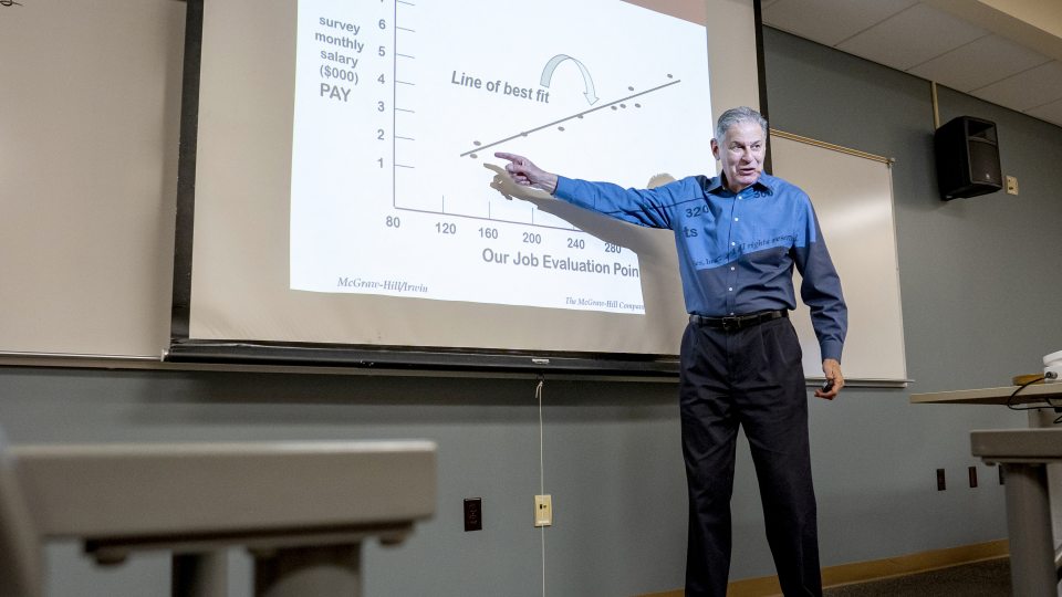 Barry Friedman points to a chart while teaching a class in Rich Hall