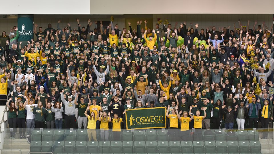 Many members of the campus community wearing green and gold