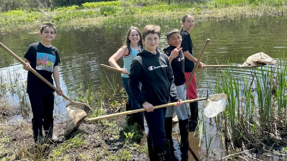 Students from Granby Elementary School explore the wetlands at Rice Creek Field Station