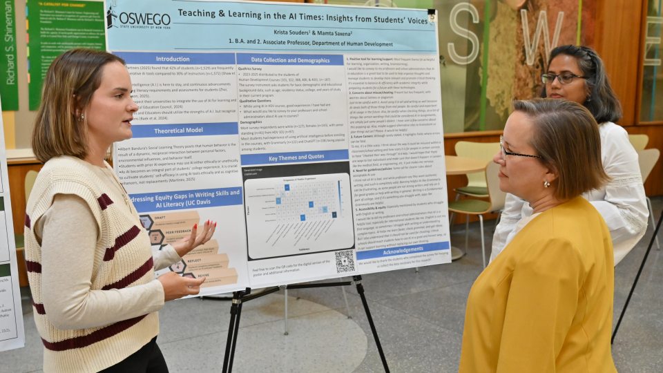 Senior human development major Krista Souders presents her research poster “Teaching and Learning in the AI Times: Insights From Students’ Voices” at the university’s Fall Poster Symposium to Kristin Croyle