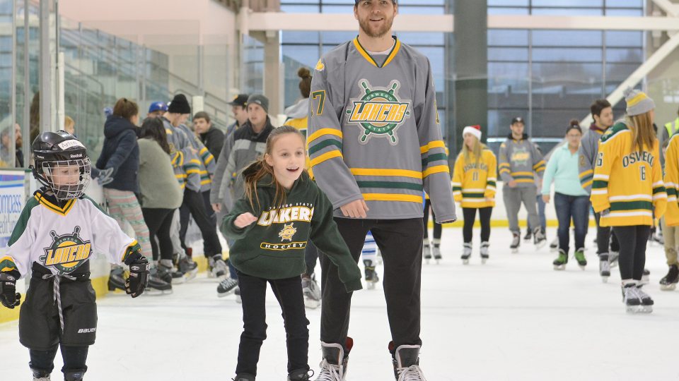 Laker hockey players skate with children