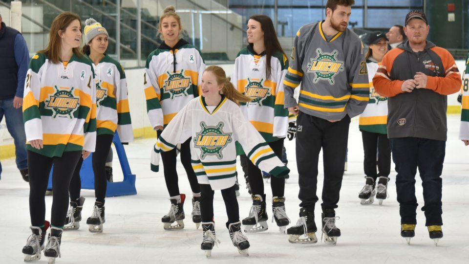 Laker hockey players skate with children