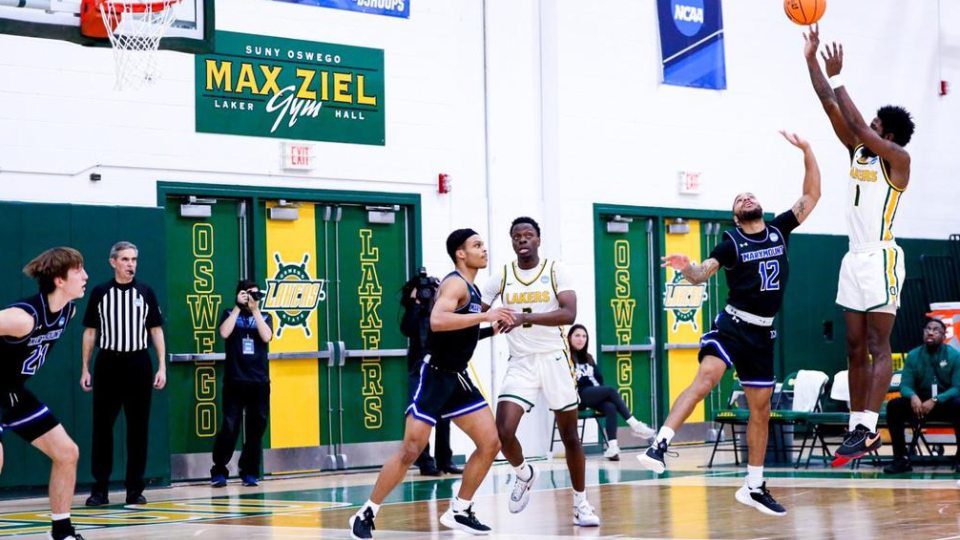An Oswego men's basketball player goes up for a jump shot during an NCAA Tournament game