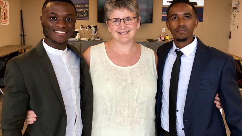 Sandra Bargainnier congratulates two of Oswego's Synergy interns