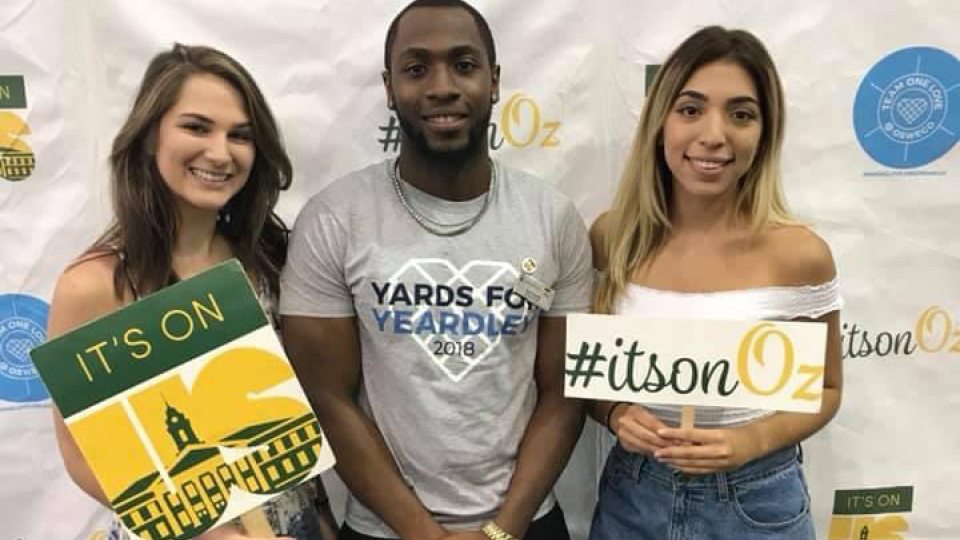 Three students show off their It's On Us T-shirts for taking the pledge to stop sexual violence