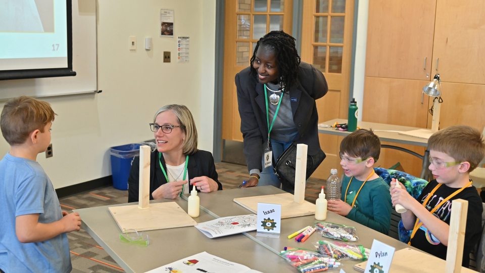 Leaders from National Grid and SUNY Oswego join children in a previous KidsTech session