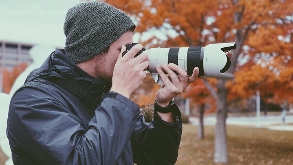 Kyle Hurley taking a photograph for the Oswego Photo Showcase project.