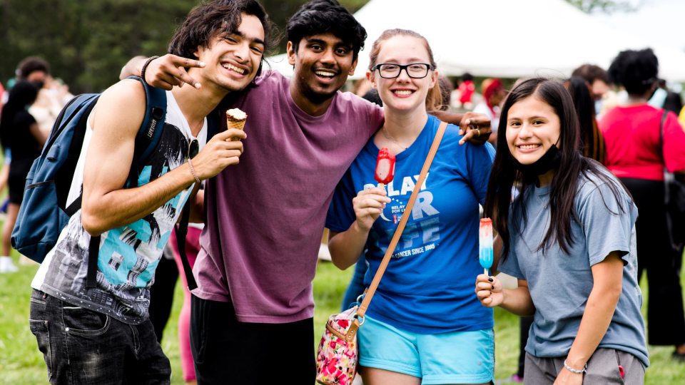 Four students pose with smiles and ice cream during 2021 LakerFest