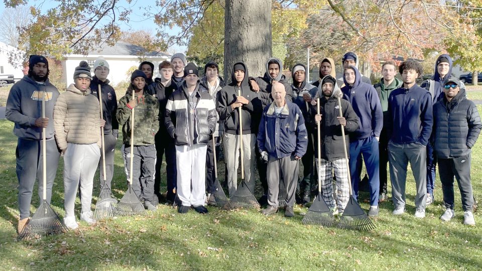 The Laker men's basketball team were among the hundreds of SUNY Oswego student-athletes raking yards for local senior citizens