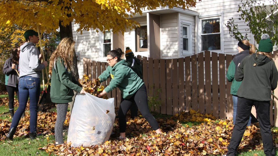 Laker student-athletes raking leaves