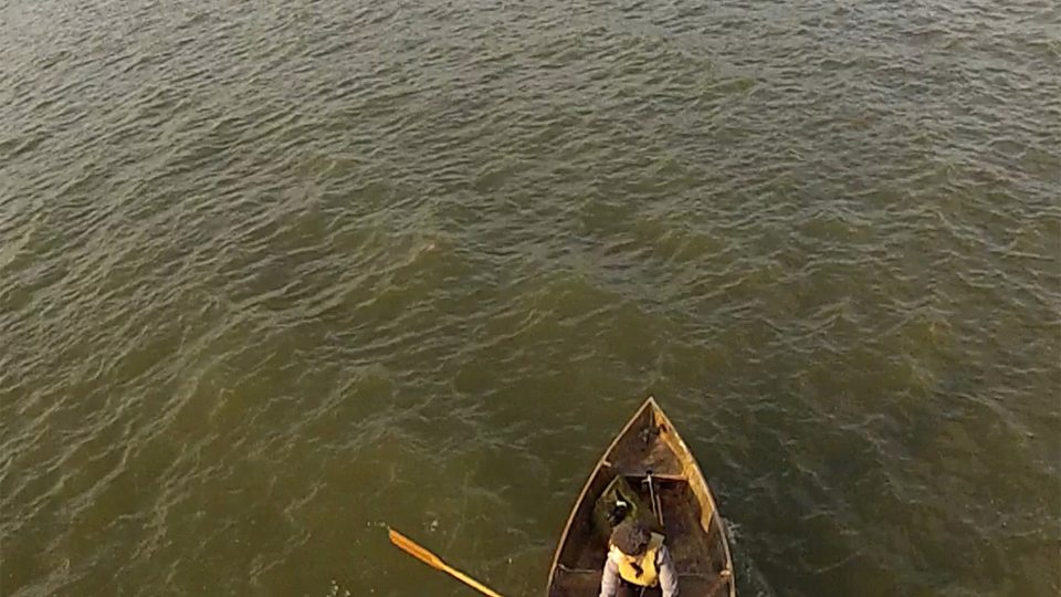 Photo of Marie Lorenz rowing a boat in New York City harbor