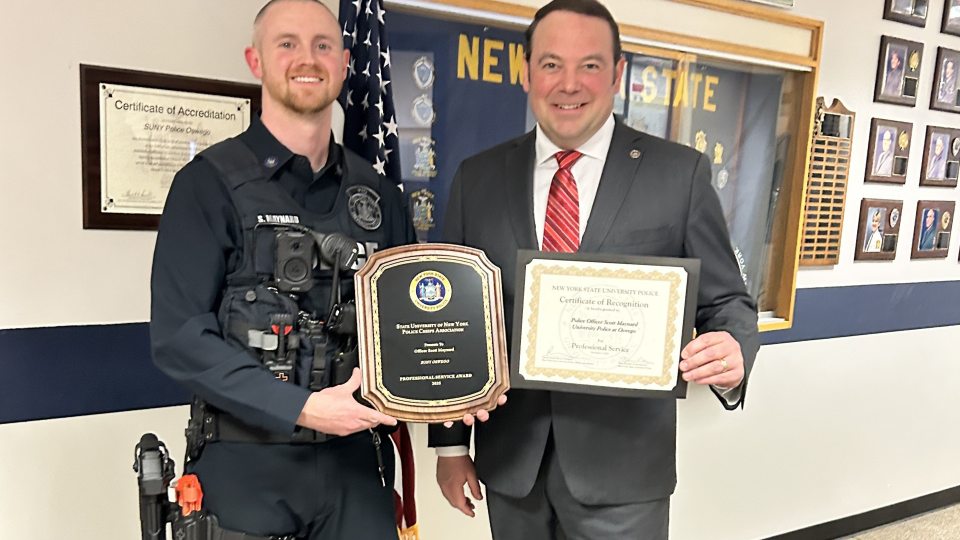 SUNY Oswego University Officer Scott Maynard (left) earned the SUNY Professional Service Award for University Police. University Police Chief Scott Swayze congratulates Maynard on this honor.