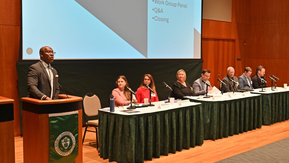 SUNY Oswego President Peter O. Nwosu (at podium) welcomes subcommittee chairs (seated) and attendees to the June 20 Oswego County Micron Strategy Steering Committee Summit