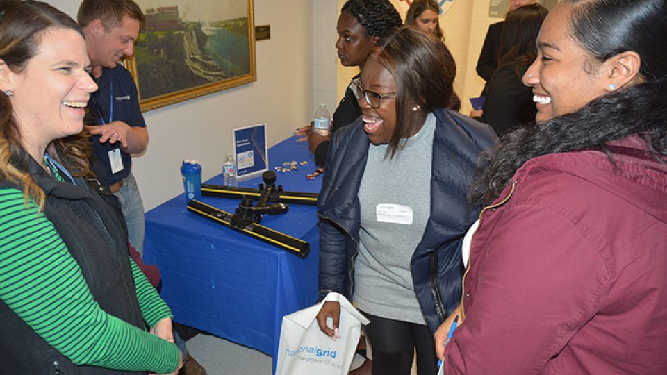 Holly Oyer, National Grid director of gas field operations in Central New York, talks with SUNY Oswego students Taylor Clark and Kariya Buckshot