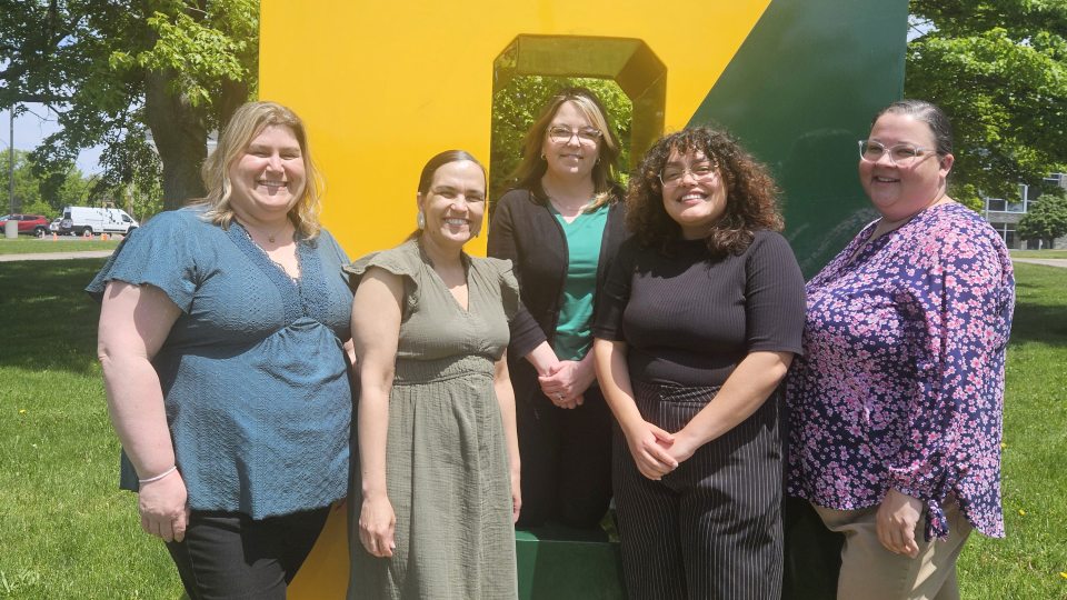 Members of the new Office of Student Wellbeing and Care gather around the Spirit O on campus