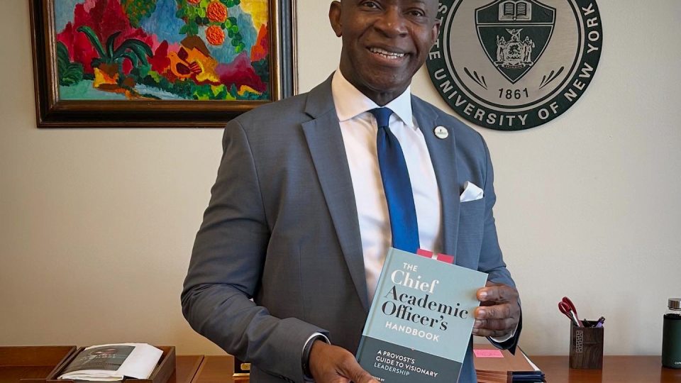 President Peter O. Nwosu with book he contributed two chapters to