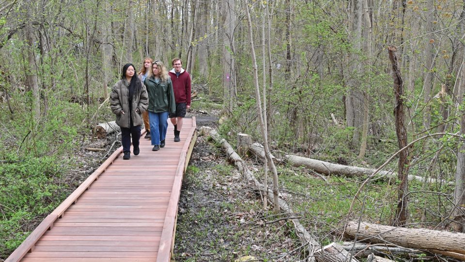 Students attending the grand opening celebration of Rice Creek Field Station's new accessible Purple Trail take a quick stroll.