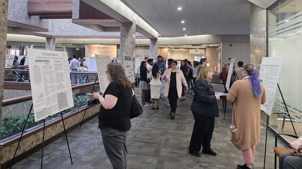 People check out poster presentations at the Syracuse Campus' Quest 2024 display