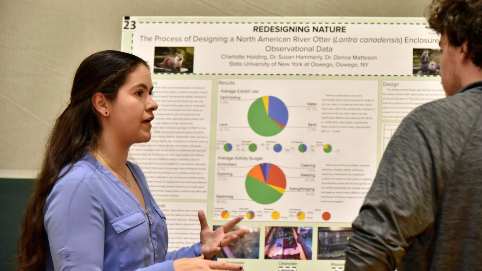 Students present research posters at the annual Quest event