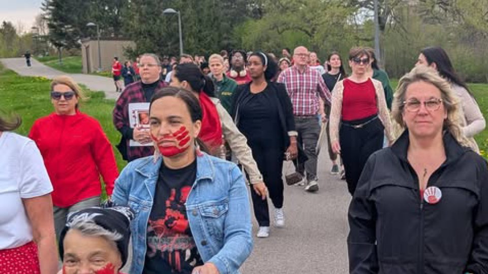 Supporters walk in honor of Red Dress Day, recognizing Missing and Murdered Indigenous Women