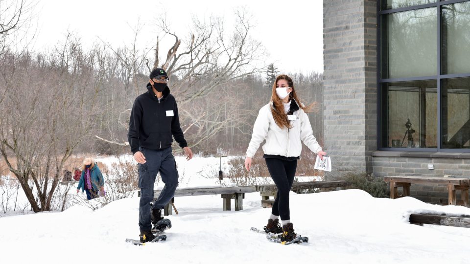 Two students take part in a snowshoe hike at Rice Creek Field Station
