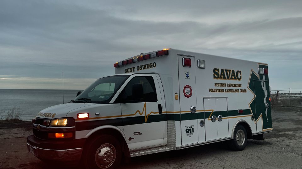 Photo of SAVAC ambulance on lakeshore at sunset