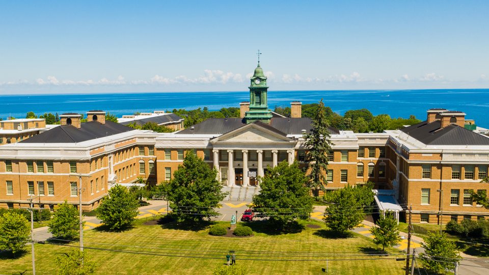Aerial view of Sheldon Hall in front of Lake Ontario