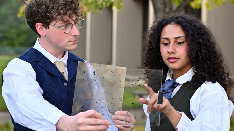 Cameron Humphrey as Peter Shaw and Chelli Lopez as Henrietta Leavitt discuss astronomical discoveries in this rehearsal photo for "Silent Sky."