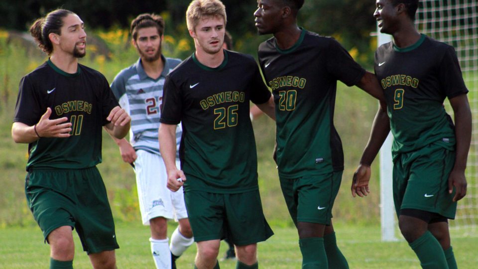 Laker men's soccer players congratulate each other