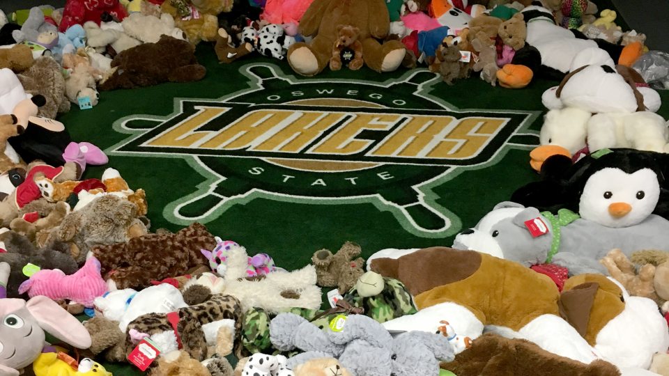 Stuffed animals ring a Lakers wheel logo in a hockey locker room