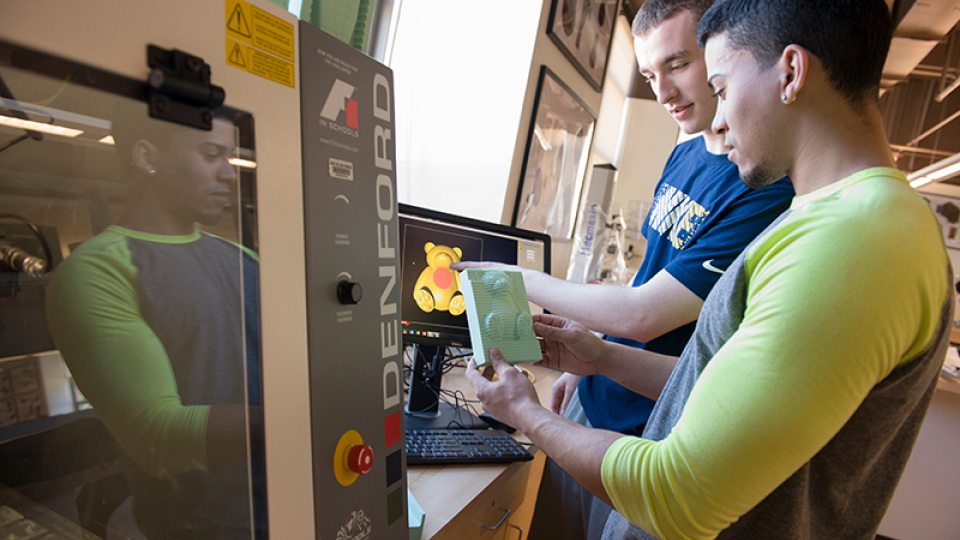 Two students using 3-D printer