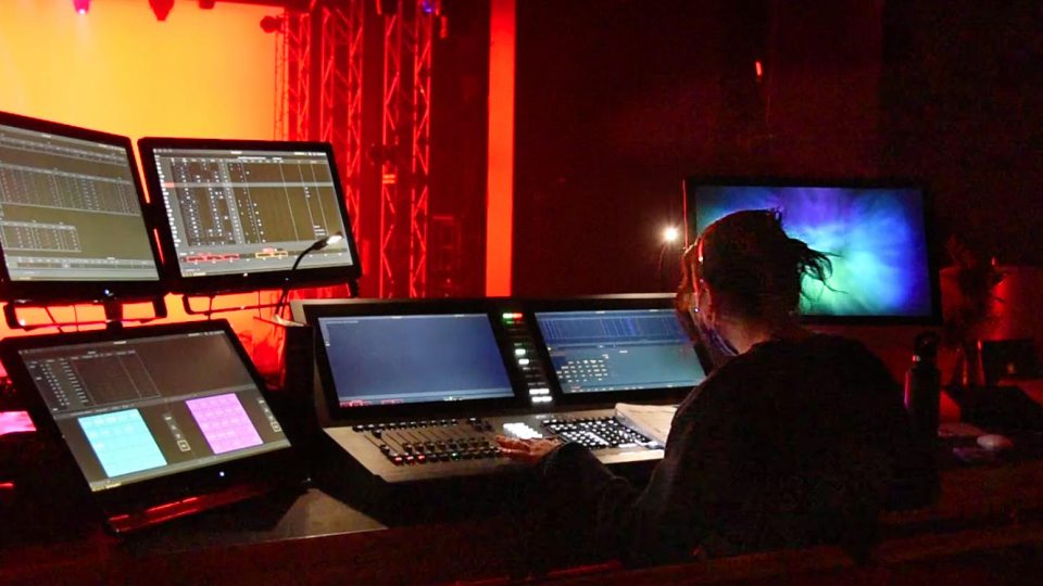 Alaina Herman, a sophomore theatre technology major, controlling the stage lighting during a test run of Going Mad in Wonderland
