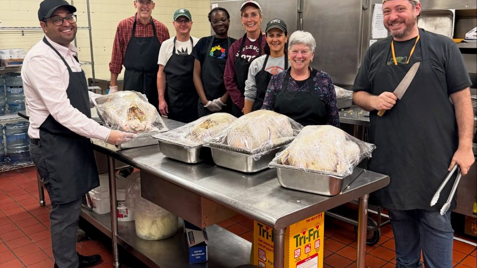 Volunteers gather in the kitchen during preparation for SUNY Oswego's Thanksgiving meal